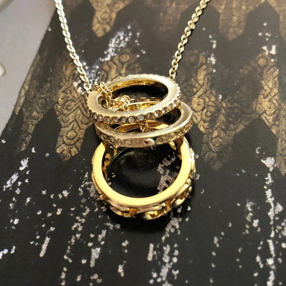 Authentic New on card. Coach Triple Gold Ring Necklace